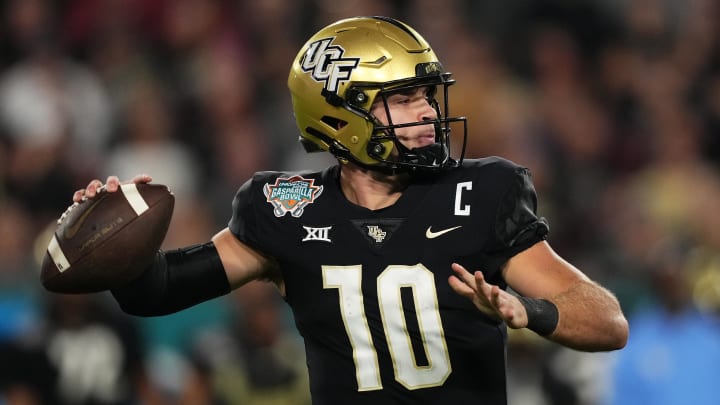 Dec 22, 2023; Tampa, FL, USA; UCF Knights quarterback John Rhys Plumlee (10) attempts a pass against the Georgia Tech Yellow Jackets during the first half of the Gasparilla Bowl at Raymond James Stadium. Mandatory Credit: Jasen Vinlove-USA TODAY Sports