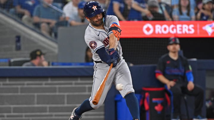 Jul 3, 2024; Toronto, Ontario, CAN; Houston Astros second baseman Jose Altuve (27) hits a RBI single in the seventh inning against the Toronto Blue Jays at Rogers Centre.