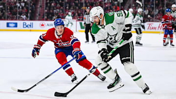 Nov 13, 2025; Montreal, Quebec, CAN; Dallas Stars center Tyler Seguin (91) plays the puck against Montreal Canadiens center Oliver Kapanen (91) during the first period at Bell Centre. Mandatory Credit: David Kirouac-Imagn Images