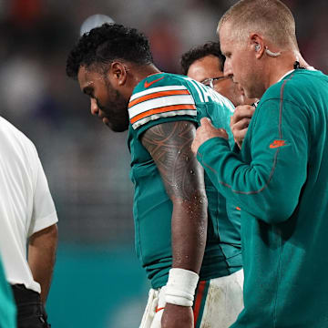 Miami Dolphins quarterback Tua Tagovailoa (1) walks off the field with training staff after sustaining a concussion during the second half against the Buffalo Bills at Hard Rock Stadium.