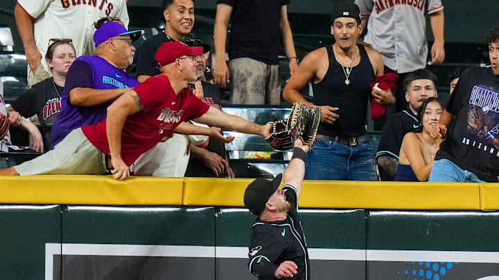 A fan catches the ball behind Tim Tawa of the Arizona Diamondbacks during the MLB game against the San Francisco Giants at Chase Field. A fan catches the ball behind Tim Tawa of the Arizona Diamondbacks during the MLB game against the San Francisco Giants at Chase Field.