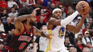 Dec 7, 2025; Chicago, Illinois, USA; Golden State Warriors guard Buddy Hield (7) drives to the basket against Chicago Bulls guard Coby White (0) during the first half at United Center. Mandatory Credit: Kamil Krzaczynski-Imagn Images