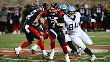 Nov 9, 2024; Montreal, Quebec, CAN; Montreal Alouettes quarterback Cody Fajardo (7) runs the ball against Toronto Argonauts defensive linesman Jake Ceresna (94) during the third quarter at Percival-Molson Memorial Stadium. Mandatory Credit: David Kirouac-Imagn Images
