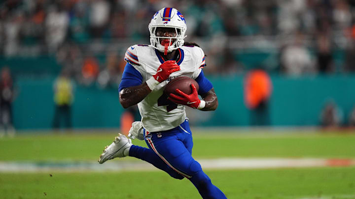 Cook runs with the ball against the Miami Dolphins during the first half at Hard Rock Stadium.