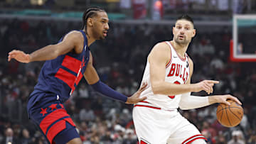 Jan 10, 2025; Chicago, Illinois, USA; Chicago Bulls center Nikola Vucevic (9) drives to the basket against Washington Wizards forward Alexandre Sarr (20) during the first half at United Center. Mandatory Credit: Kamil Krzaczynski-Imagn Images
