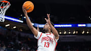Mar 12, 2025; Indianapolis, IN, USA; Ohio State Buckeyes forward Sean Stewart (13) shoots the ball while Iowa Hawkeyes forward Ladji Dembele (13) defends in the second half  at Gainbridge Fieldhouse. Mandatory Credit: Trevor Ruszkowski-Imagn Images