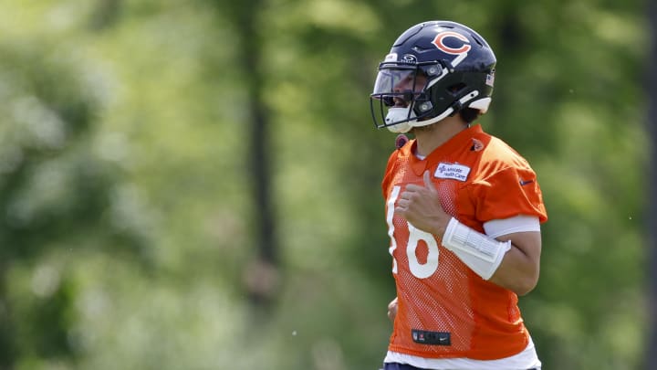 May 31, 2024; Lake Forest, IL, USA; Chicago Bears quarterback Caleb Williams (18) runs on the field during organized team activities at Halas Hall. Mandatory Credit: Kamil Krzaczynski-USA TODAY Sports