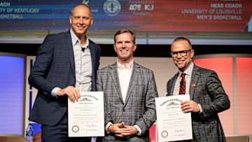 Kentucky Governor Andy Beshear, center, posed for a photo onstage after giving Kentucky basketball coach Mark Pope and Louisville basketball coach Pat Kelsey the title of Kentucky Colonel at the 2024 Leadership Louisville Luncheon at the Kentucky International Convention Center in downtown Louisville on Wednesday, August 28, 2024.