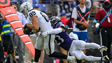 Sep 15, 2024; Baltimore, Maryland, USA; Las Vegas Raiders tight end Brock Bowers (89) runs with the ball while being tackled by Baltimore Ravens linebacker Trenton Simpson (23) during the second half at M&T Bank Stadium. Mandatory Credit: Reggie Hildred-Imagn Images