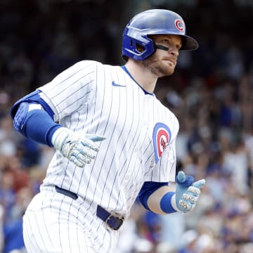 Jun 19, 2024; Chicago, Illinois, USA; Chicago Cubs outfielder Ian Happ (8) rounds the bases after hitting a solo home run against the San Francisco Giants during the fourth inning at Wrigley Field.