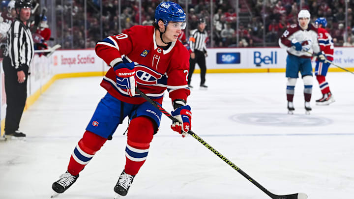 Mar 22, 2025; Montreal, Quebec, CAN; Montreal Canadiens left wing Juraj Slafkovsky (20) plays the puck against the Colorado Avalanche in the third period at Bell Centre. Mandatory Credit: David Kirouac-Imagn Images