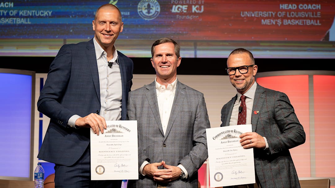 Kentucky Governor Andy Beshear, center, posed for a photo onstage after giving Kentucky basketball coach Mark Pope and Louisville basketball coach Pat Kelsey the title of Kentucky Colonel at the 2024 Leadership Louisville Luncheon at the Kentucky International Convention Center in downtown Louisville on Wednesday, August 28, 2024.