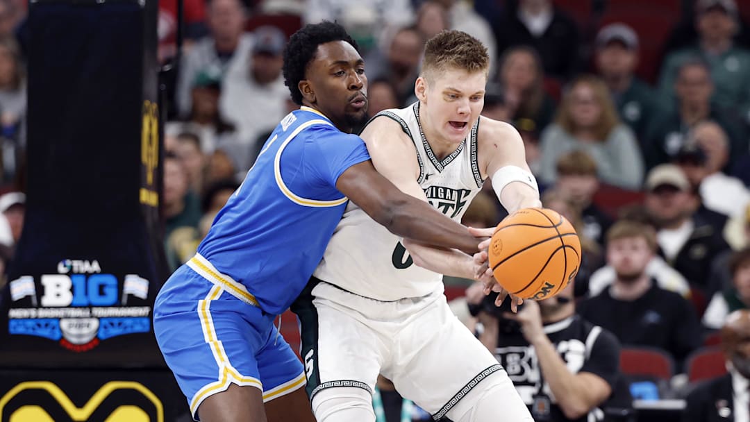Mar 13, 2026; Chicago, IL, USA; UCLA Bruins center Xavier Booker (1) defends against Michigan State Spartans forward Jaxon Kohler (0) during the first half at United Center. Mandatory Credit: Kamil Krzaczynski-Imagn Images