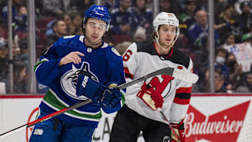 Vancouver Canucks defenseman Quinn Hughes shares laugh with his brother New Jersey Devils forward Jack Hughes.