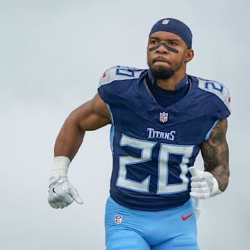 Tennessee Titans running back Tony Pollard (20) emerges from the smoke before the Titans play the Bengals at Nissan Stadium in Nashville, Tenn., Sunday, Dec. 15, 2024.