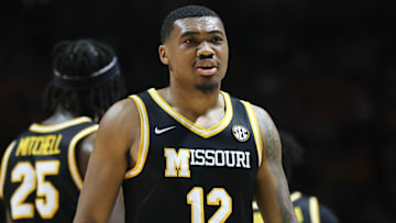 Missouri Tigers guard Tony Perkins (12) looks down the court, in a game against the Arkansas Razorbacks this season.