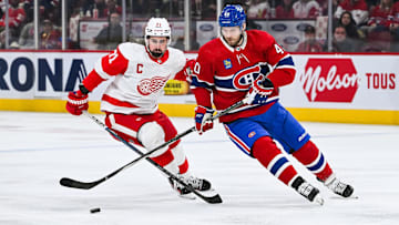 Dec 2, 2023; Montreal, Quebec, CAN; Montreal Canadiens right wing Joel Armia (40) plays the puck against Detroit Red Wings center Dylan Larkin (71) during the first period at Bell Centre. Mandatory Credit: David Kirouac-Imagn Images