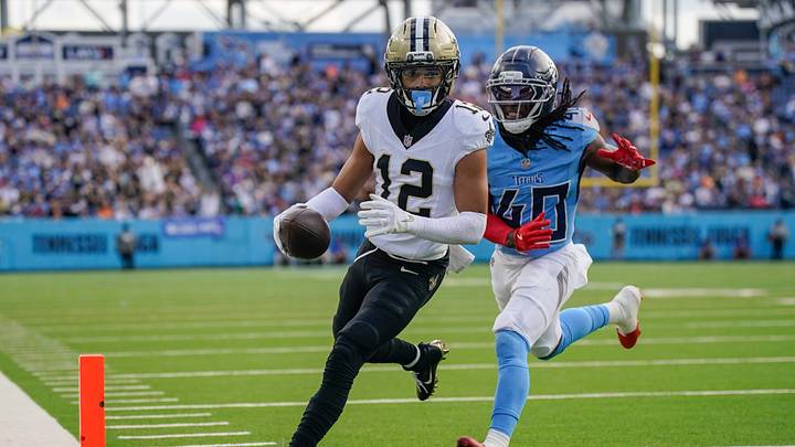 New Orleans Saints wide receiver Chris Olave (12) runs in a touchdown in front of Tennessee Titans cornerback Kemon Hall (40) during the third quarter at Nissan Stadium in Nashville, Tenn., Sunday, Dec. 28, 2025.