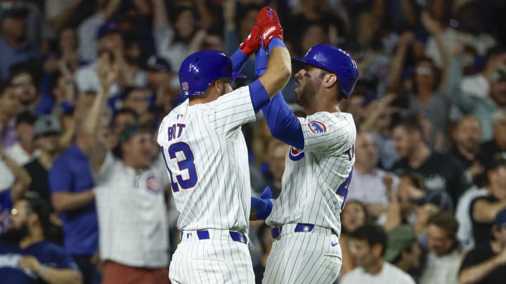 Jun 5, 2024; Chicago, Illinois, USA; Chicago Cubs outfielder Mike Tauchman (40) celebrates with shortstop David Bote (13) after scoring against the Chicago White Sox during the seventh inning at Wrigley Field.