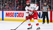 Apr 16, 2025; Montreal, Quebec, CAN; Carolina Hurricanes defenseman Brent Burns (8) considers his options with the puck against the Montreal Canadiens in the second period at Bell Centre. Mandatory Credit: David Kirouac-Imagn Images