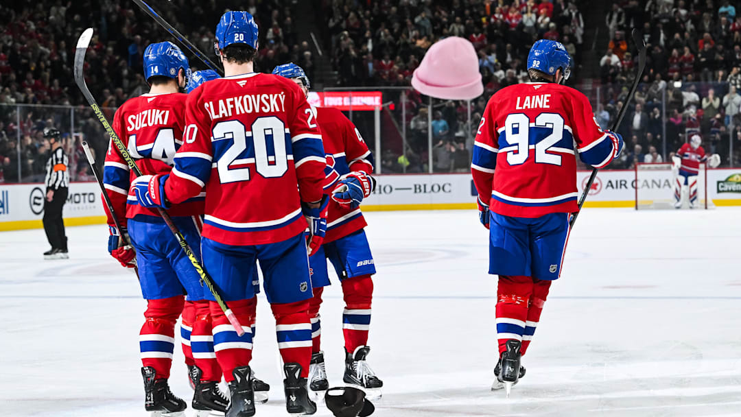 Dec 17, 2024; Montreal, Quebec, CAN; Montreal Canadiens right wing Patrik Laine (92) skates back to the bench after his third goal as hats fly on the ice against the Buffalo Sabres during the second period at Bell Centre. Mandatory Credit: David Kirouac-Imagn Images