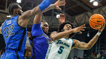 Jan 30, 2025; New Orleans, Louisiana, USA;  Tulane Green Wave guard Mari Jordan (5) drives to the basket against Memphis Tigers center Moussa Cisse (32) during the second half at Avron B. Fogelman Arena in Devlin Fieldhouse.