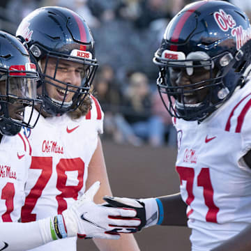 Oct 8, 2022; Nashville, Tennessee, USA;  Mississippi Rebels wide receiver Jonathan Mingo (1) celebrates withy teammates Jeremy James (78) and Jayden Williams (71) after a 71 yard touchdown catch against the Vanderbilt Commodores during the third quarter at FirstBank Stadium.  Mandatory Credit: George Walker IV - Imagn Images