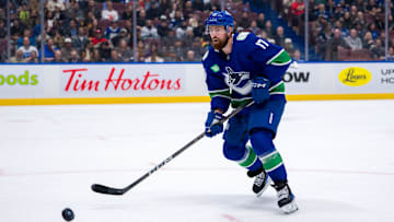 Nov 12, 2024; Vancouver, British Columbia, CAN; Vancouver Canucks defenseman Filip Hronek (17) looks for the loose puck against the Calgary Flames during the second period at Rogers Arena. Mandatory Credit: Bob Frid-Imagn Images