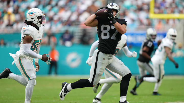 Nov 19, 2023; Miami Gardens, Florida, USA; Las Vegas Raiders tight end Michael Mayer (87) catches a pass in front of Miami Dolphins linebacker Jerome Baker (55) during the second half at Hard Rock Stadium. Mandatory Credit: Jasen Vinlove-USA TODAY Sports