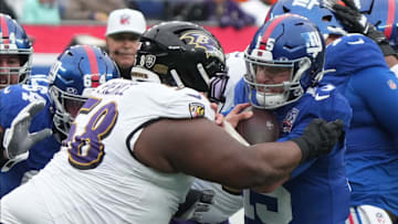 East Rutherford, NJ -- December 15, 2024 -- Michael Pierce of the Ravens hits Tommy DeVito of the Giants taking a late hit penalty in the first half. The Baltimore Ravens came to MetLife Stadium to play the New York Giants.