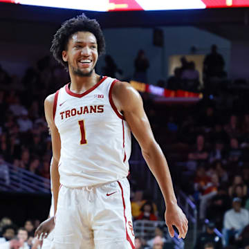 Feb 1, 2025; Los Angeles, California, USA;  USC Trojans guard Desmond Claude (1) smiles while shooting a free throw against the Michigan State Spartans during the first half at Galen Center. Mandatory Credit: William Navarro-Imagn Images