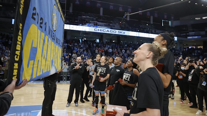 May 24, 2022; Chicago, Illinois, USA; Members of the Chicago Sky look on as the 2021 WNBA Championship Banner is revealed during a championship ring ceremony before a WNBA basketball game against the Indiana Fever at Wintrust Arena. Mandatory Credit: Kamil Krzaczynski-Imagn Images