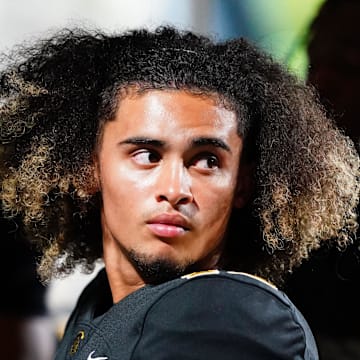 Oct 20, 2023; Carrollton, GA, USA; Carrollton Trojans quarterback Julian Lewis (10) watches on from the sidelines against the Westlake Lions during the first half at Grisham Stadium. The 15-year-old Carrollton High student has already committed to playing for the University of Southern California Trojans and has been considered one of the top high school quarterback prospects.