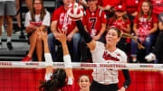 Oct 21, 2023; Lincoln, NE, USA; Nebraska Cornhuskers middle blocker Andi Jackson (15) attacks against Wisconsin Badgers middle blocker Caroline Crawford (9) during the fourth set at the Bob Devaney Sports Center.