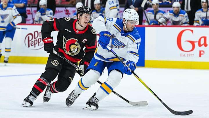 Dec 6, 2025; Ottawa, Ontario, CAN; St. Louis Blues defenseman Cam Fowler (17) defends against Ottawa Senators left wing Brady Tkachuk (7) during the third period at Canadian Tire Centre. Mandatory Credit: David Kirouac-Imagn Images