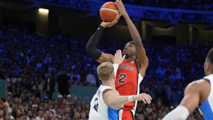 Jul 27, 2024; Villeneuve-d'Ascq, France; Canada guard Shai Gilgeous-Alexander (2) shoots against Greece point guard Thomas Walkup (0) in the first quarter during the Paris 2024 Olympic Summer Games at Stade Pierre-Mauroy. Mandatory Credit: John David Mercer-USA TODAY Sports