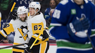 Oct 28, 2022; Vancouver, British Columbia, CAN; Pittsburgh Penguins forward Bryan Rust (17) and forward Rickard Rakell (67) celebrate Rakell   s goal against the Vancouver Canucks in the second period at Rogers Arena.  Mandatory Credit: Bob Frid-Imagn Images