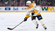 Dec 5, 2024; Montreal, Quebec, CAN; Nashville Predators defenseman Alexandre Carrier (45) plays the puck against the Montreal Canadiens  during the third period at Bell Centre. Mandatory Credit: David Kirouac-Imagn Images