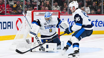 Feb 13, 2025; Montreal, Quebec, CAN; [Imagn Images direct customers only] Team Finland goalie Juuse Saros (74) makes a save near forward Mikko Rantanen (96) against Team USA in the third period during a 4 Nations Face-Off ice hockey game at Bell Centre. Mandatory Credit: David Kirouac-Imagn Images