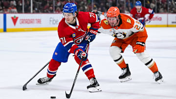 Dec 9, 2024; Montreal, Quebec, CAN; Montreal Canadiens center Jake Evans (71) plays the puck against Anaheim Ducks center Mason McTavish (23) during the second period at Bell Centre. Mandatory Credit: David Kirouac-Imagn Images