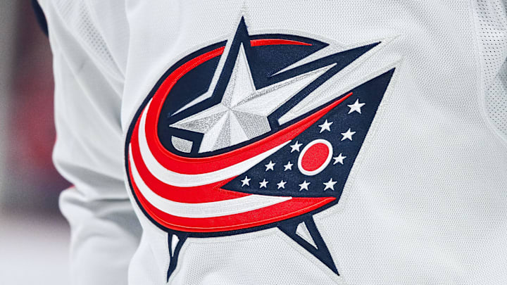 Mar 12, 2024; Montreal, Quebec, CAN; View of a Columbus Blue Jackets logo on a jersey worn by a member of the team during warm-up before the game against the Montreal Canadiens at Bell Centre. Mar 12, 2024; Montreal, Quebec, CAN; View of a Columbus Blue Jackets logo on a jersey worn by a member of the team during warm-up before the game against the Montreal Canadiens at Bell Centre.