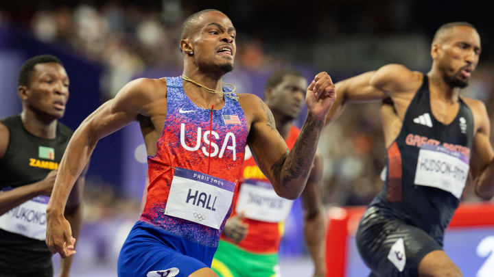 Hall surged from behind in fourth place to win Olympic gold in the men's 400.