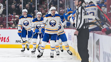 Dec 17, 2024; Montreal, Quebec, CAN; Buffalo Sabres center Dylan Cozens (24) celebrates his goal with his teammates at the bench against the Montreal Canadiens during the second period at Bell Centre. Mandatory Credit: David Kirouac-Imagn Images