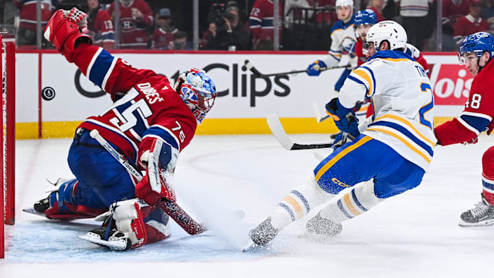 May 16, 2026; Montreal, Quebec, CAN; Montreal Canadiens goalie Jakub Dobes (75) makes a save against Buffalo Sabres defenseman Mattias Samuelsson (23) during the second period in game six of the second round of the 2026 Stanley Cup Playoffs at Bell Centre. Mandatory Credit: David Kirouac-Imagn Images