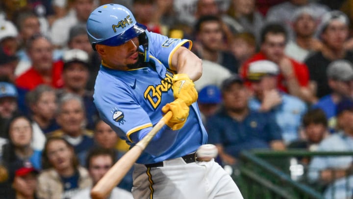 Aug 17, 2024; Milwaukee, Wisconsin, USA; Milwaukee Brewers shortstop Willy Adames (27) hits a double against the Cleveland Guardians in the seventh inning at American Family Field. Mandatory Credit: Benny Sieu-USA TODAY Sports