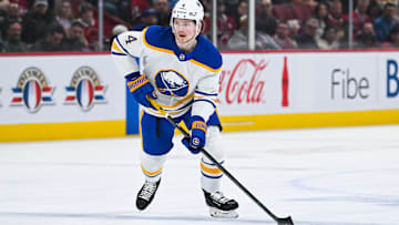 Dec 17, 2024; Montreal, Quebec, CAN; Buffalo Sabres defenseman Bowen Byram (4) plays the puck against the Montreal Canadiens during the first period at Bell Centre. Mandatory Credit: David Kirouac-Imagn Images