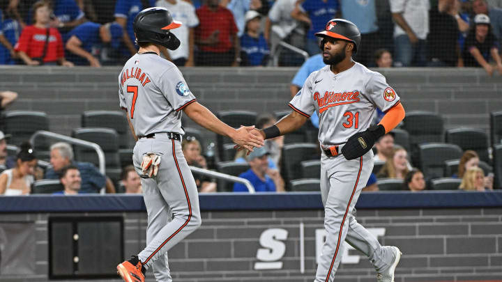 Aug 8, 2024; Toronto, Ontario, CAN; Baltimore Orioles second base Jackson Holliday (7) and center field Cedric Mullins (31) celebrate the two run single by left field Colton Cowser (17) in the ninth inning against the Toronto Blue Jays at Rogers Centre. Mandatory Credit: Gerry Angus-USA TODAY Sports