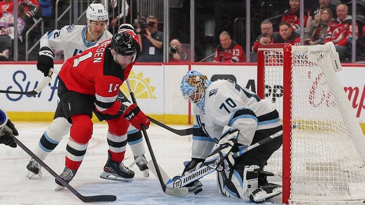 Jan 3, 2026; Newark, New Jersey, USA; Utah Mammoth goaltender Karel Vejmelka (70) makes a save on New Jersey Devils right wing Stefan Noesen (11) during the second period at Prudential Center. Mandatory Credit: Ed Mulholland-Imagn Images