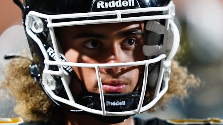 Oct 20, 2023; Carrollton, GA, USA; Carrollton Trojans quarterback Julian Lewis (10) watches on from the sidelines against the Westlake Lions during the first half at Grisham Stadium. The 15-year-old Carrollton High student has already committed to playing for the University of Southern California Trojans and has been considered one of the top high school quarterback prospects. Mandatory Credit: John David Mercer-Imagn Images