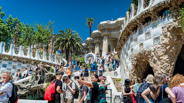 Tourists are seen taking pictures at the Park Güell terrace in Barcelona, Spain.
